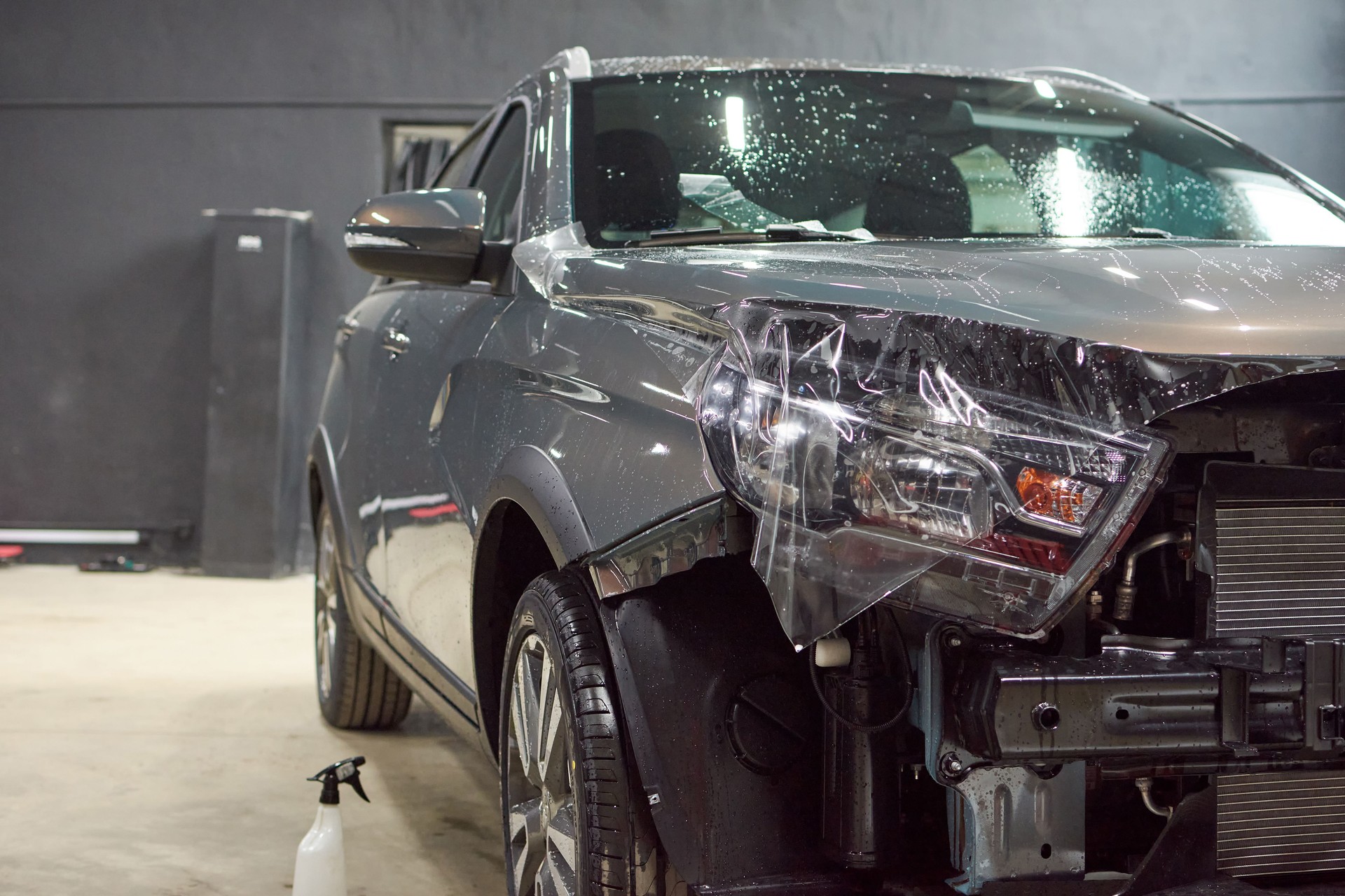 Installation of a protective paint and varnish transparent film on the car. PPF polyurethane film to protect the car paint from stones and scratches.